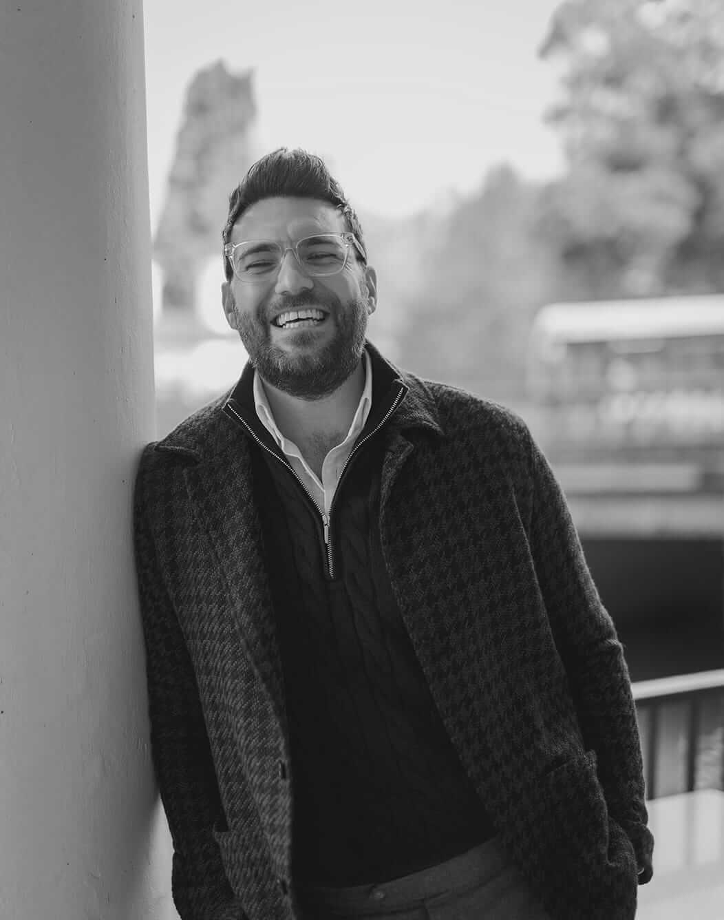 Smiling man in a dark quilted jacket.